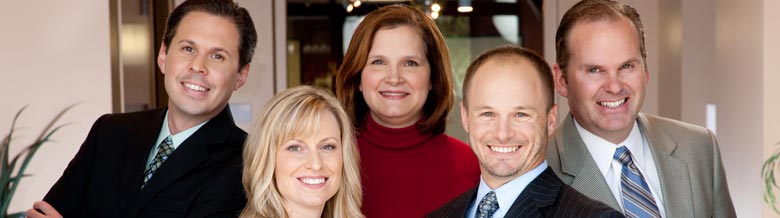 Five members of the Jimenez Consulting team standing in front of the office.